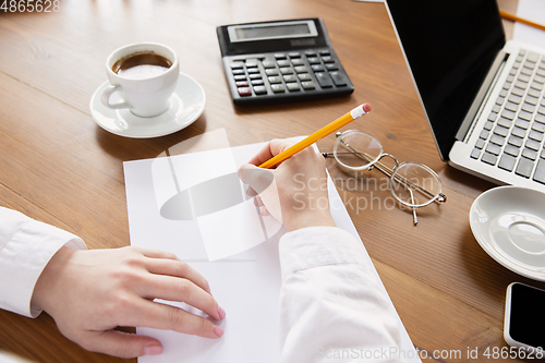 Image of Close up of caucasian female hands, working in office, business, people