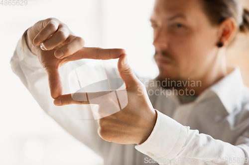 Image of Close up of caucasian male hands, working in office, business, people