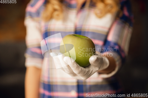 Image of Close up of female hand holding green apple, healthy food, fruits