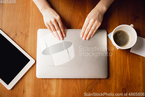 Image of Close up of caucasian female hands during working in office, studying, top view