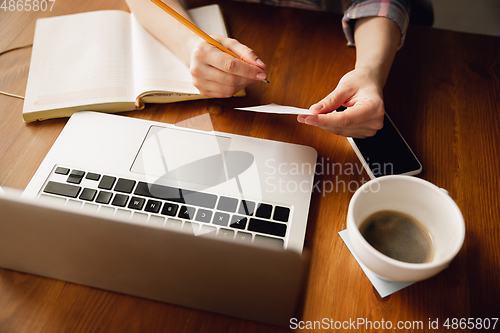 Image of Close up of caucasian female hands during working in office, studying
