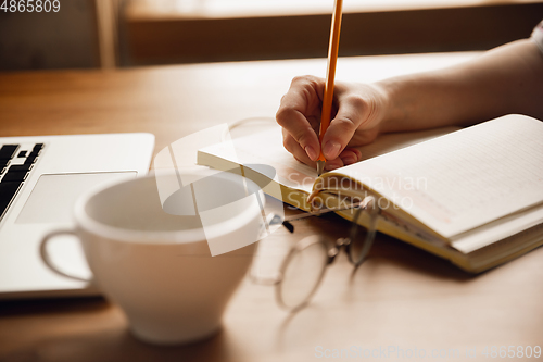 Image of Close up of caucasian female hands during working in office, studying