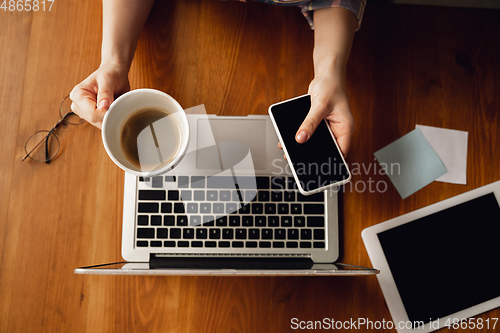 Image of Close up of caucasian female hands during working in office, studying, top view