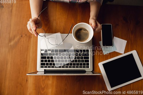 Image of Close up of caucasian female hands during working in office, studying, top view