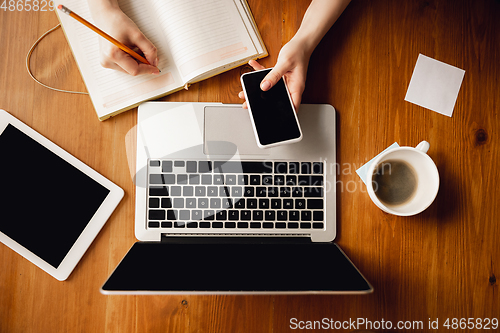 Image of Close up of caucasian female hands during working in office, studying, top view