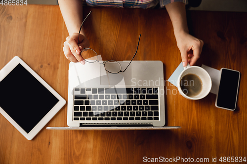 Image of Close up of caucasian female hands during working in office, studying, top view