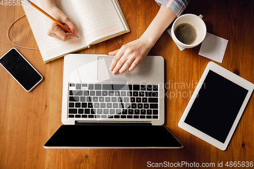 Image of Close up of caucasian female hands during working in office, studying, top view