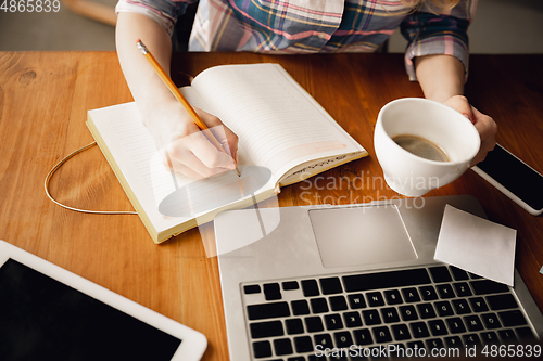 Image of Close up of caucasian female hands during working in office, studying