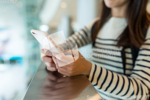 Image of Woman use of mobile phone in shopping mall