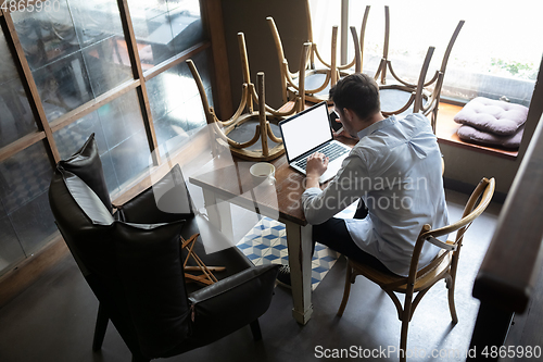 Image of Restaurant, cafe, bar closed due to COVID-19 or Coronavirus outbreak lockdown, stressed owner of small business trying to find solution, top view