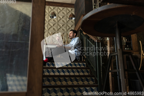 Image of Public institutions closed due to COVID-19 or Coronavirus outbreak lockdown, stressed owner of small business alone in his cafe, restaurant, bar