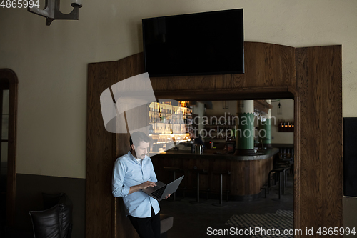 Image of Public institutions closed due to COVID-19 or Coronavirus outbreak lockdown, stressed owner of small business alone in his cafe, looking for solution