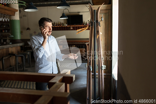 Image of Restaurant, cafe, bar closed due to COVID-19 or Coronavirus outbreak lockdown, stressed owner of small business trying to find solution