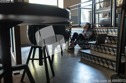 Image of Public institutions closed due to COVID-19 or Coronavirus outbreak lockdown, stressed owner of small business alone in his cafe, restaurant, bar