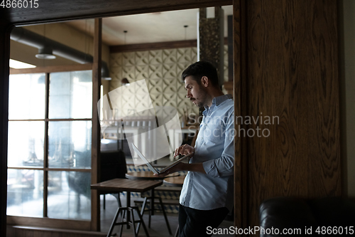 Image of Public institutions closed due to COVID-19 or Coronavirus outbreak lockdown, stressed owner of small business alone in his cafe, looking for solution