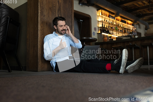 Image of Restaurant, cafe, bar closed due to COVID-19 or Coronavirus outbreak lockdown, stressed owner of small business trying to find solution