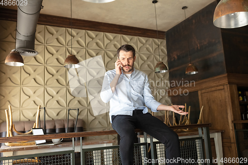 Image of Restaurant, cafe, bar closed due to COVID-19 or Coronavirus outbreak lockdown, stressed owner of small business trying to find solution