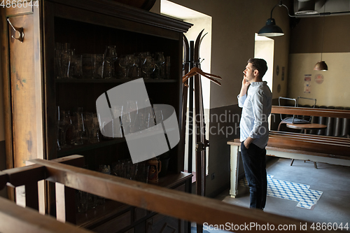 Image of Restaurant, cafe, bar closed due to COVID-19 or Coronavirus outbreak lockdown, stressed owner of small business trying to find solution