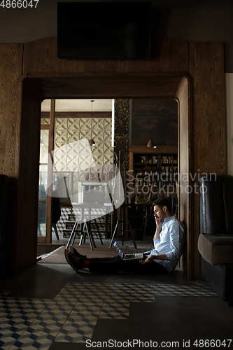 Image of Public institutions closed due to COVID-19 or Coronavirus outbreak lockdown, stressed owner of small business alone in his cafe, despair lying down the floor