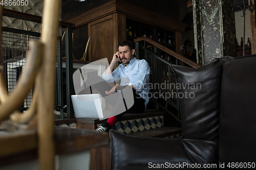 Image of Restaurant, cafe, bar closed due to COVID-19 or Coronavirus outbreak lockdown, stressed owner of small business trying to find solution