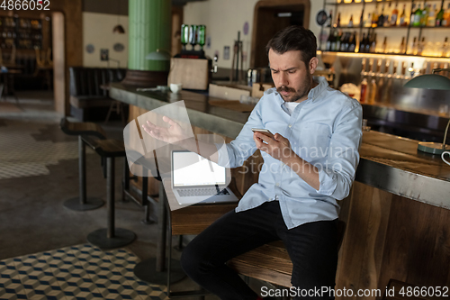 Image of Public institutions closed due to COVID-19 or Coronavirus outbreak lockdown, stressed owner of small business alone in his cafe, restaurant, bar