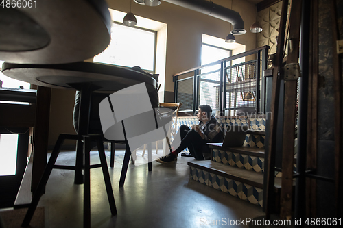 Image of Public institutions closed due to COVID-19 or Coronavirus outbreak lockdown, stressed owner of small business alone in his cafe, restaurant, bar