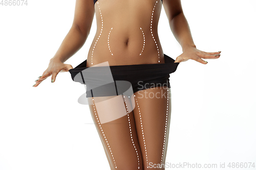 Image of Beautiful female legs and belly on white background. Beauty, cosmetics, spa, bodycare and lifting, correction surgery, fitness concept