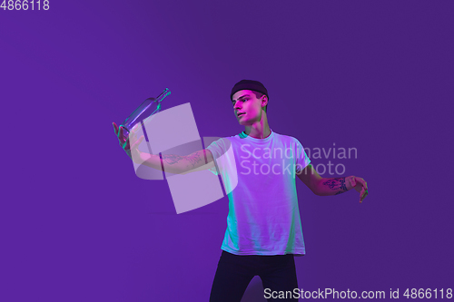 Image of Caucasian man\'s portrait isolated on purple studio background in neon light