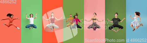 Image of Young emotional people jumping high, look happy and cheerful on multicolored background