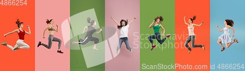 Image of Young emotional people jumping high, look happy and cheerful on multicolored background