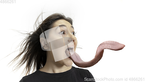 Image of Smiling girl opening her mouth and showing the long big giant tongue isolated on white background, crazy and attracted