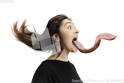 Image of Smiling girl opening her mouth and showing the long big giant tongue isolated on white background, crazy and attracted