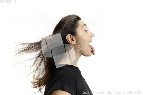 Image of Smiling girl opening her mouth and showing the long big giant tongue isolated on white background, crazy and attracted