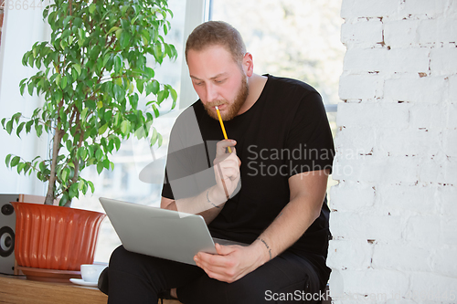 Image of Young man studying at home during online courses for engineers, doctors, ecologists