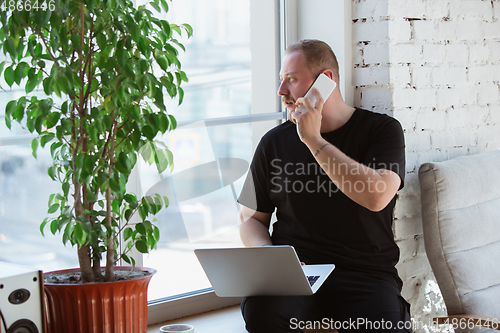 Image of Young man studying at home during online courses for analytics, financists, economists