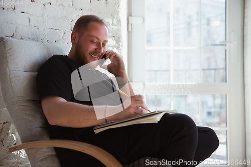 Image of Young man studying at home during online courses for managers, marketers, buyers