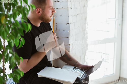 Image of Young man studying at home during online courses for engineers, doctors, ecologists