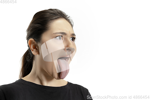 Image of Smiling girl opening her mouth and showing the long big giant tongue isolated on white background, crazy and attracted