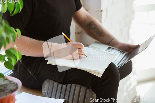 Image of Young man studying at home during online courses for engineers, doctors, ecologists