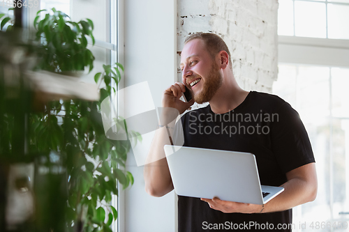 Image of Young man studying at home during online courses for designers, consultants, IT-managers