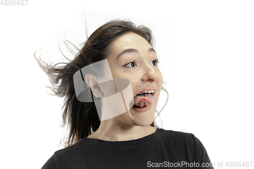 Image of Smiling girl opening her mouth and showing the long big giant tongue isolated on white background, crazy and attracted