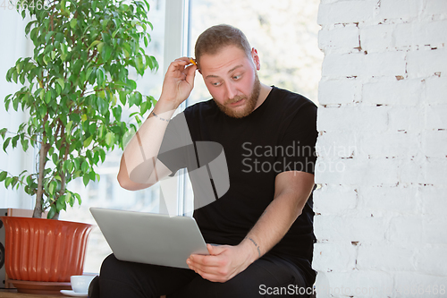 Image of Young man studying at home during online courses for engineers, doctors, ecologists