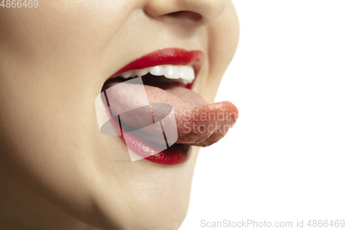 Image of Smiling girl opening her mouth with red lips and showing the long big giant tongue isolated on white background, crazy and attracted, close up