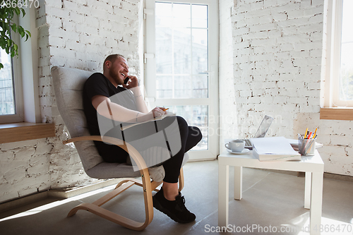 Image of Young man studying at home during online courses for managers, marketers, buyers