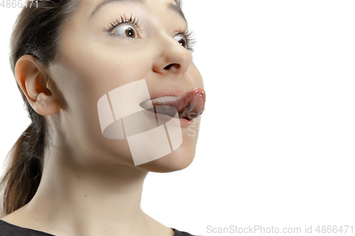 Image of Smiling girl opening her mouth and showing the long big giant tongue isolated on white background, crazy and attracted