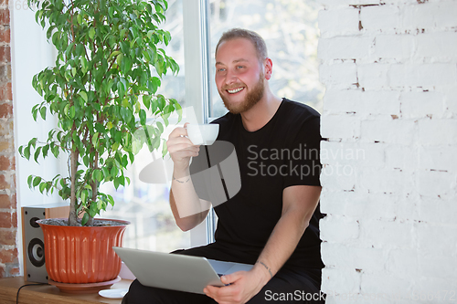 Image of Young man studying at home during online courses for designers, consultants, IT-managers