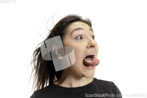 Image of Smiling girl opening her mouth and showing the long big giant tongue isolated on white background, crazy and attracted