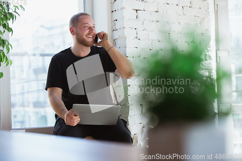 Image of Young man studying at home during online courses for designers, consultants, IT-managers