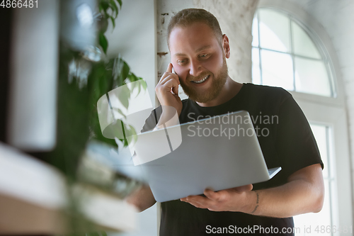 Image of Young man studying at home during online courses for designers, consultants, IT-managers