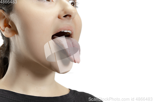 Image of Smiling girl opening her mouth and showing the long big giant tongue isolated on white background, crazy and attracted